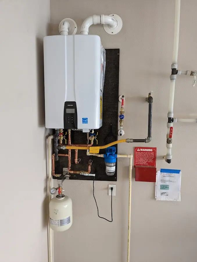 Professional plumber installing copper piping in a Carrollton home